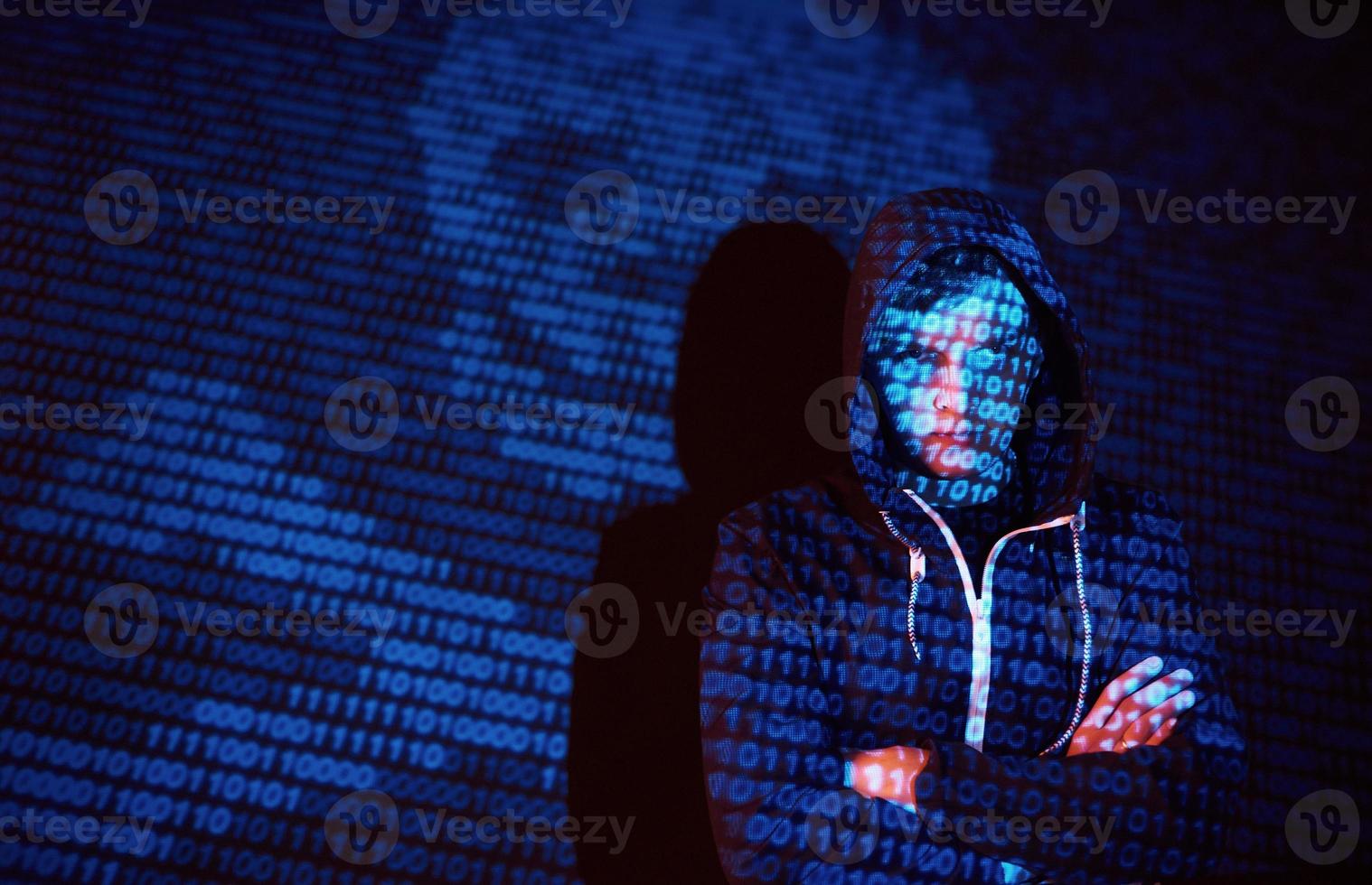 Cyber attack with unrecognizable hooded hacker using virtual reality, digital glitch effect photo