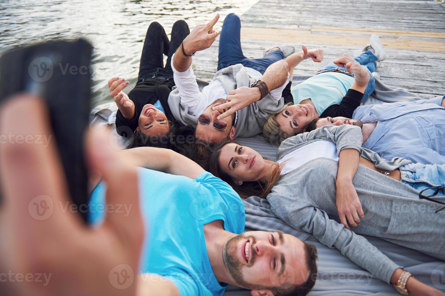 Portrait of happy young friends doing selfie photo