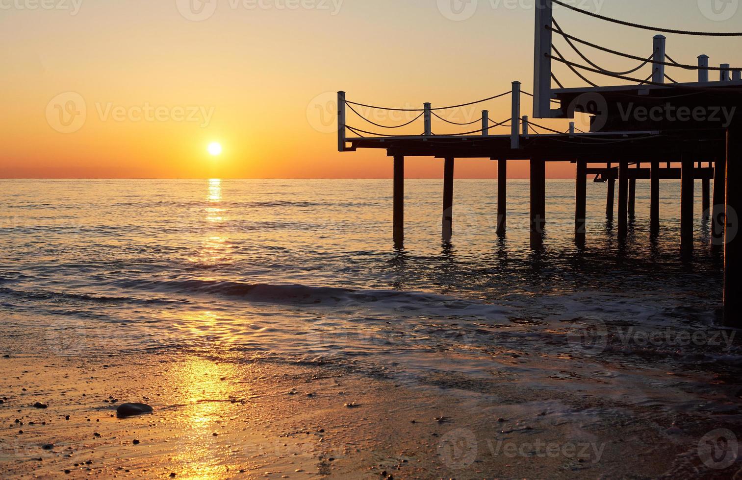 Wooden bridge pier against a beautiful sky measure used for natural background, background and multi-stage sea photo