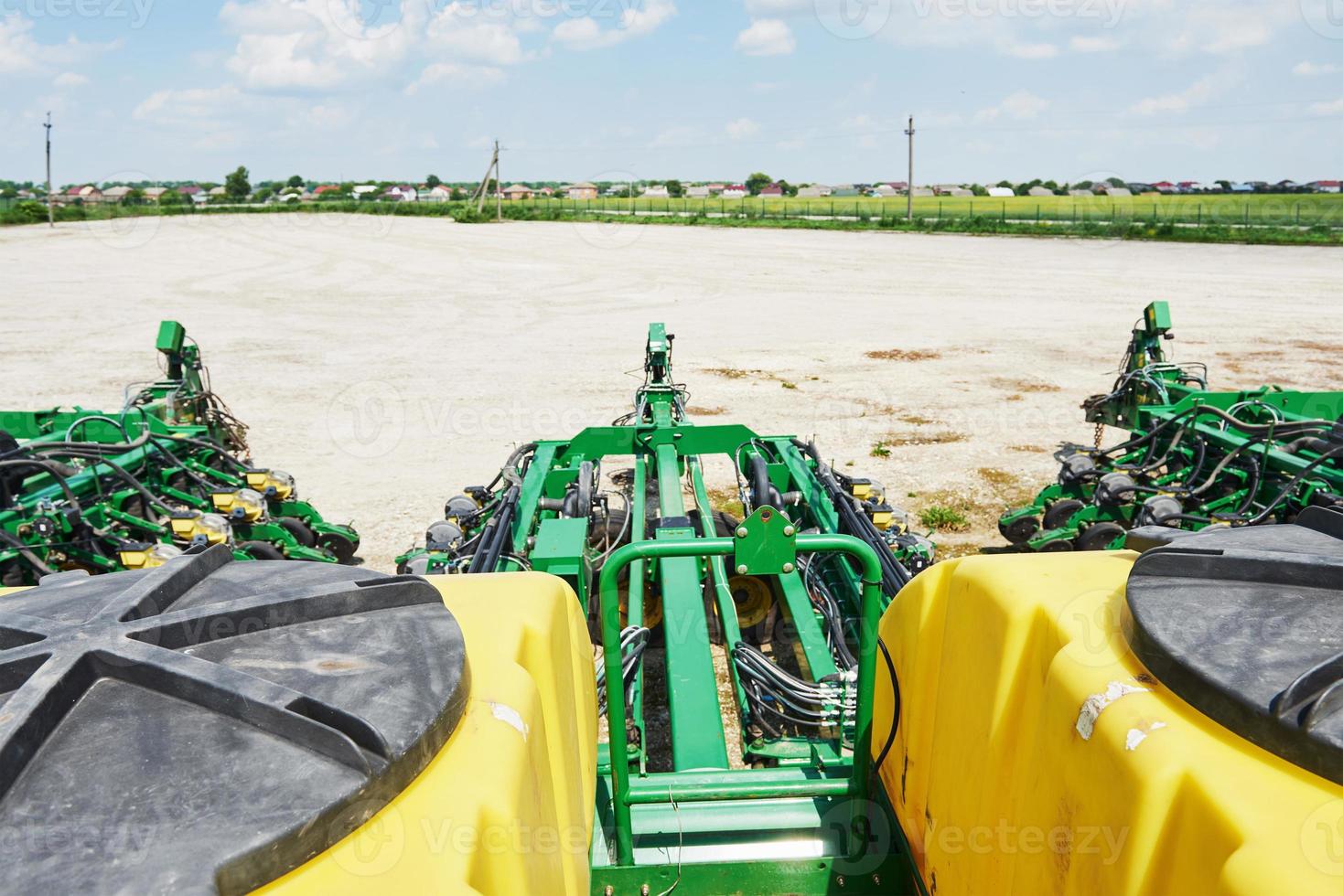 Close up of seeder attached to tractor in field. Agricultural machinery for spring works sowing photo