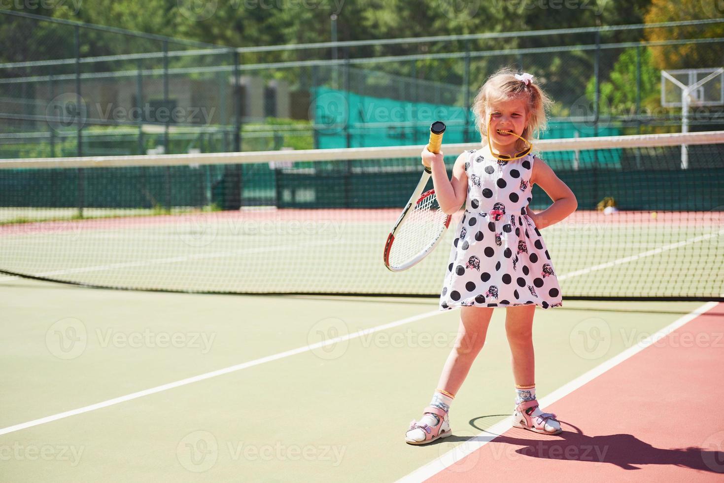 Little tennis girl cute little girl playing tennis on the tennis court outside 6221054 Stock  Photo at Vecteezy