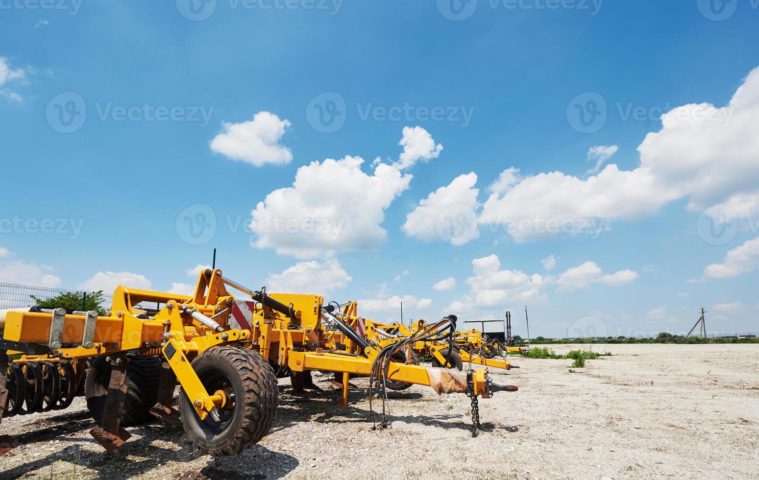 Close up of seeder attached to tractor in field. Agricultural machinery for spring works sowing photo