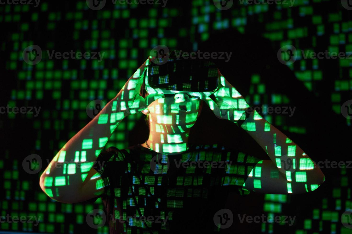 Double exposure of a caucasian man and Virtual reality headset is presumably a gamer or a hacker cracking the code into a secure network or server, with lines of code photo