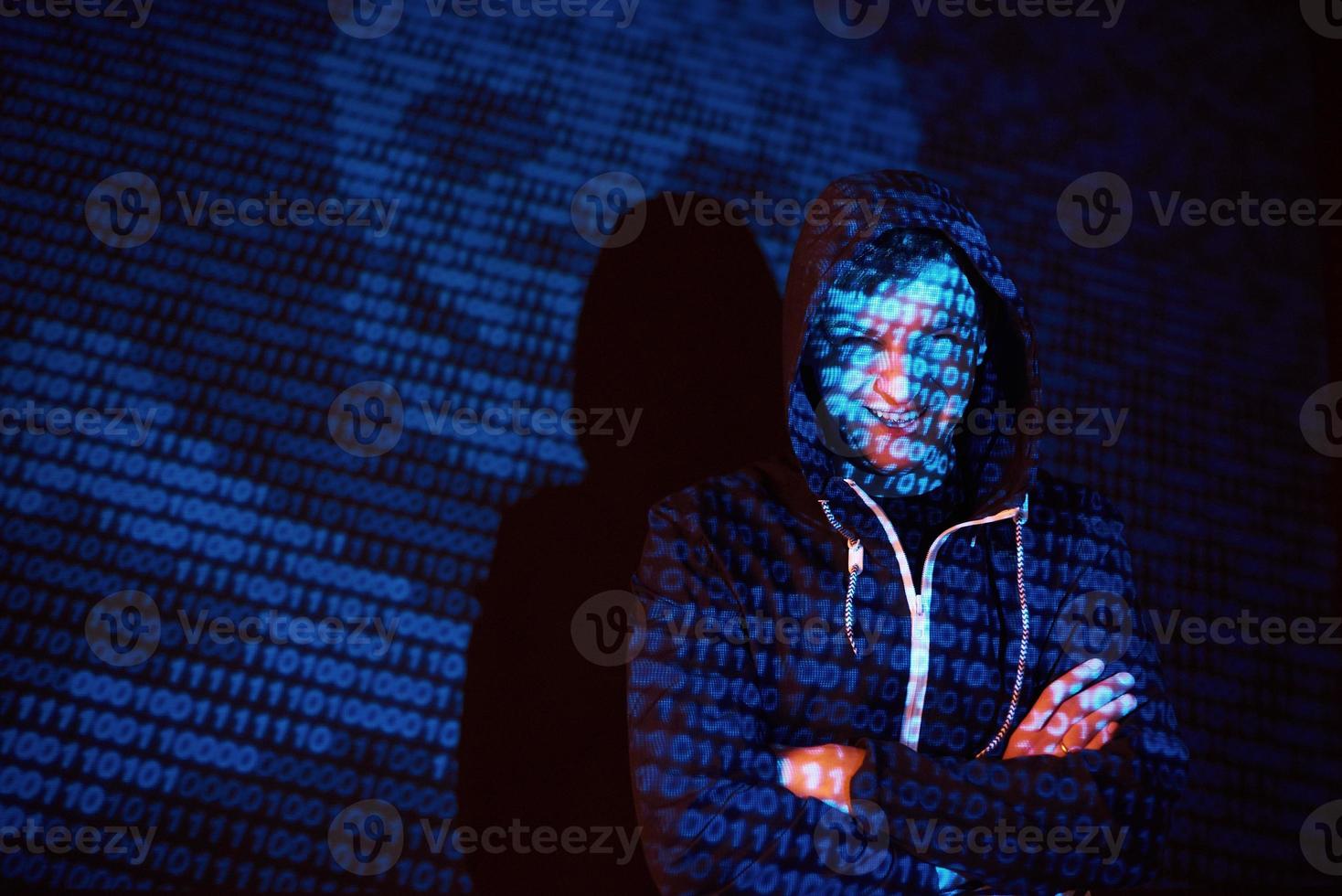 Cyber attack with unrecognizable hooded hacker using virtual reality, digital glitch effect photo