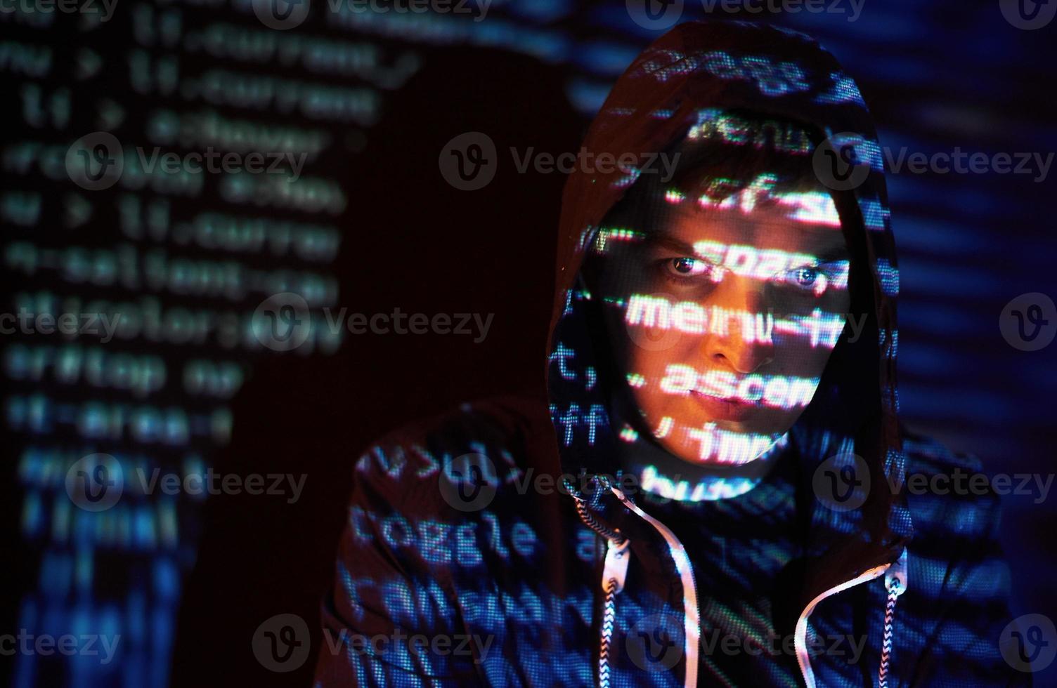 Cyber attack with unrecognizable hooded hacker using virtual reality, digital glitch effect photo