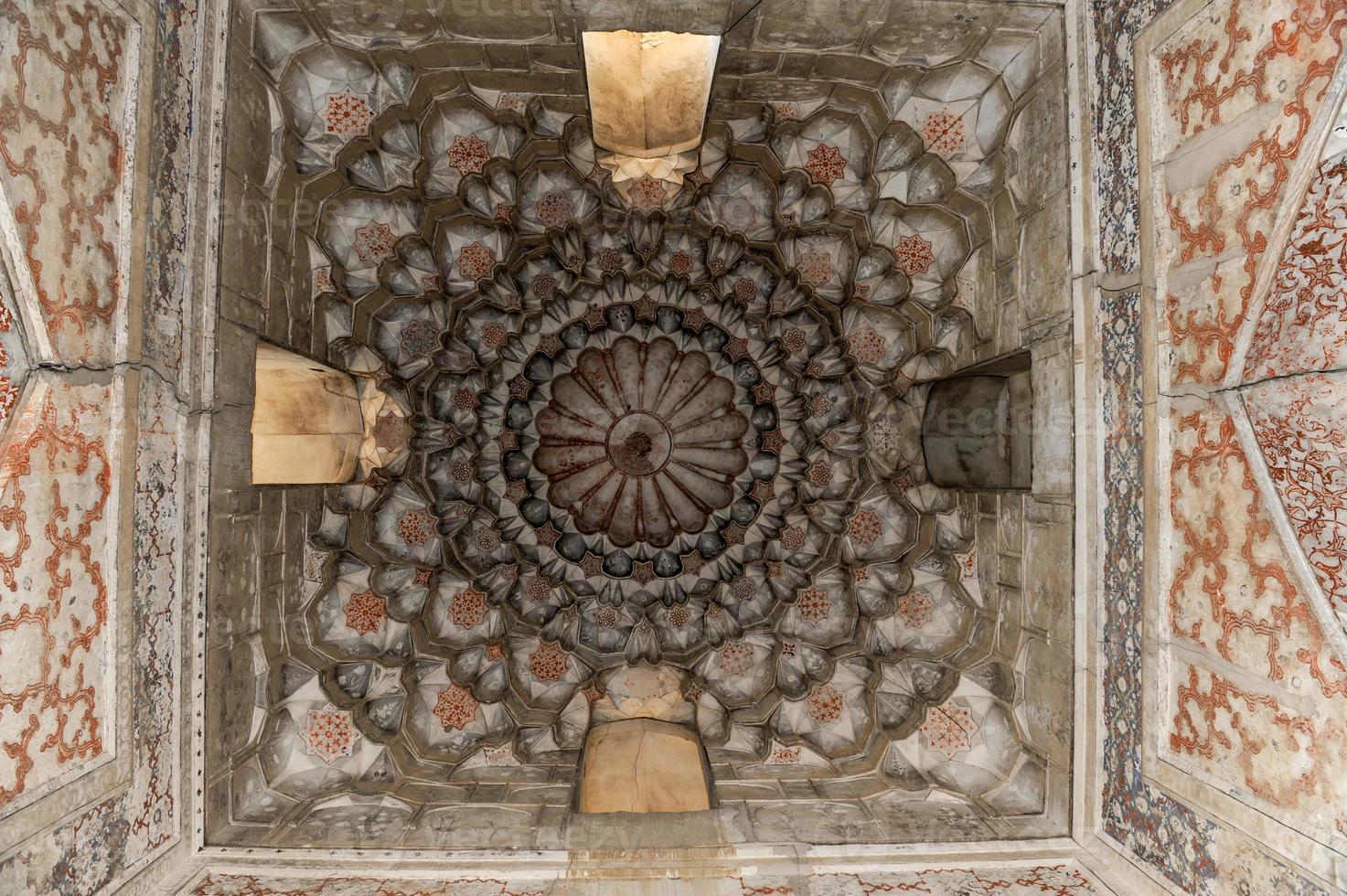 Elements of ancient architecture of Central Asia. Ceiling in the form of a dome in a traditional ancient Asian mosaic photo