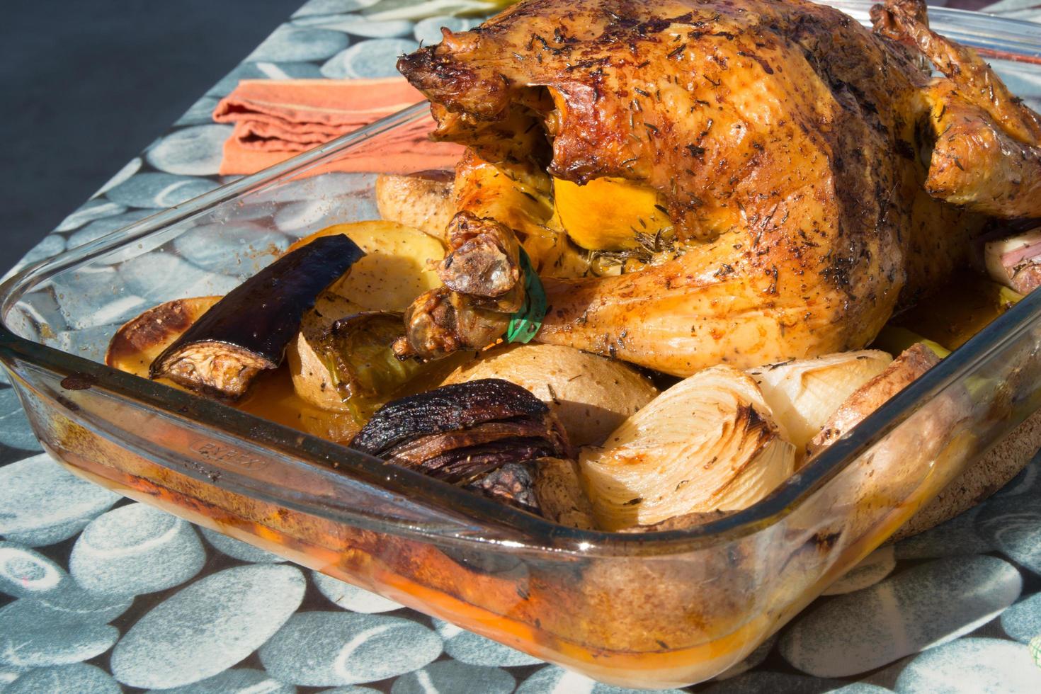 Delicious organic poultry with onions, zucchini and potatoes in a baking dish. Ready to eat, Close up photo