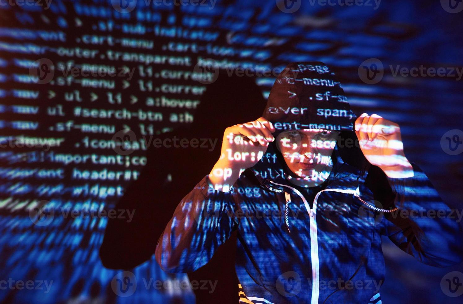 Cyber attack with unrecognizable hooded hacker using virtual reality, digital glitch effect photo