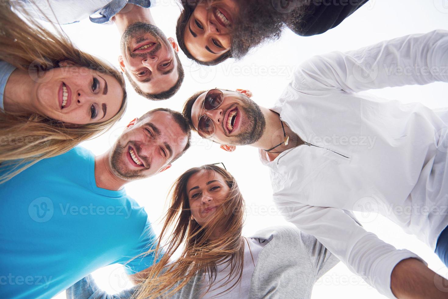 summer vacation, happy people - a group of teenagers looking down with a happy smile on his face. photo