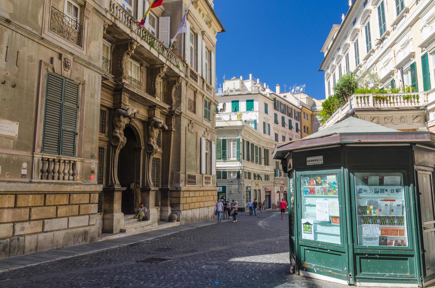 Genoa, Italy, September 11, 2018 Palace Palazzo Grimaldi della Meridiana, typical colorful buildings, old bookstall kiosk on Piazza della Meridiana square in historical centre of city Genova, Liguria photo