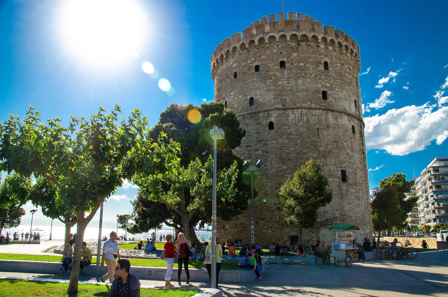 Thessaloniki, Greece - May 14, 2016 people walking on the coast in Thessaloniki next to the White tower photo