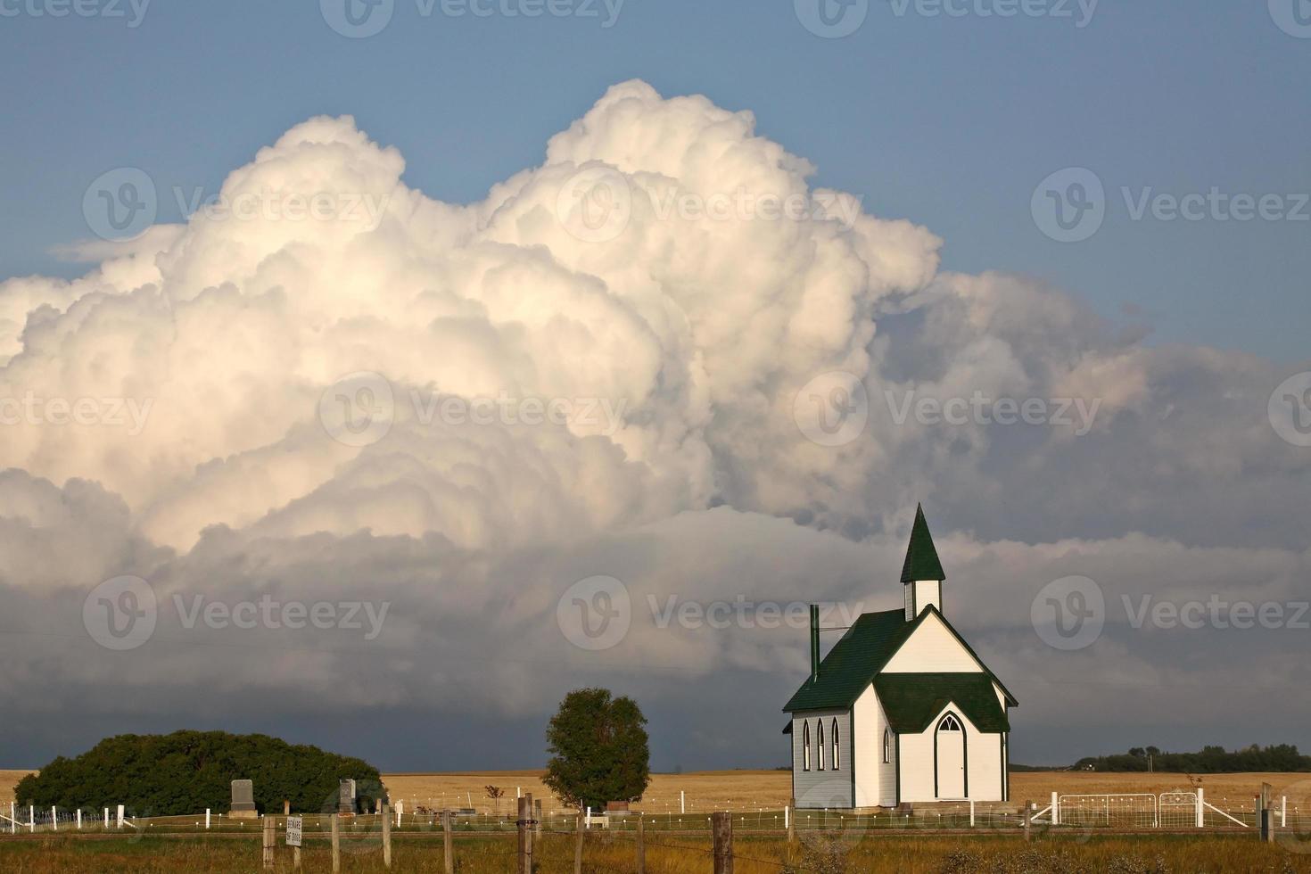 Thunderhead clouds forming behind a country church photo