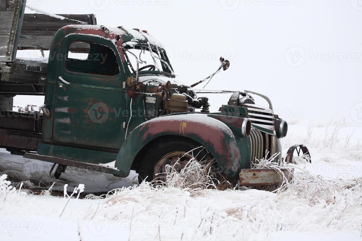 Abandoned old farm truck in winter photo