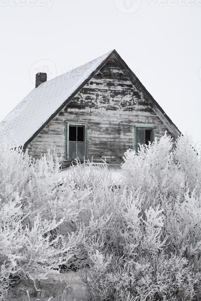 Abandoned farm house in winter photo