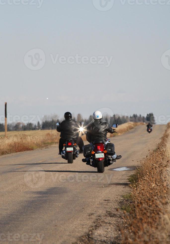 Motorcyclists drving down a Saskatchewan road photo