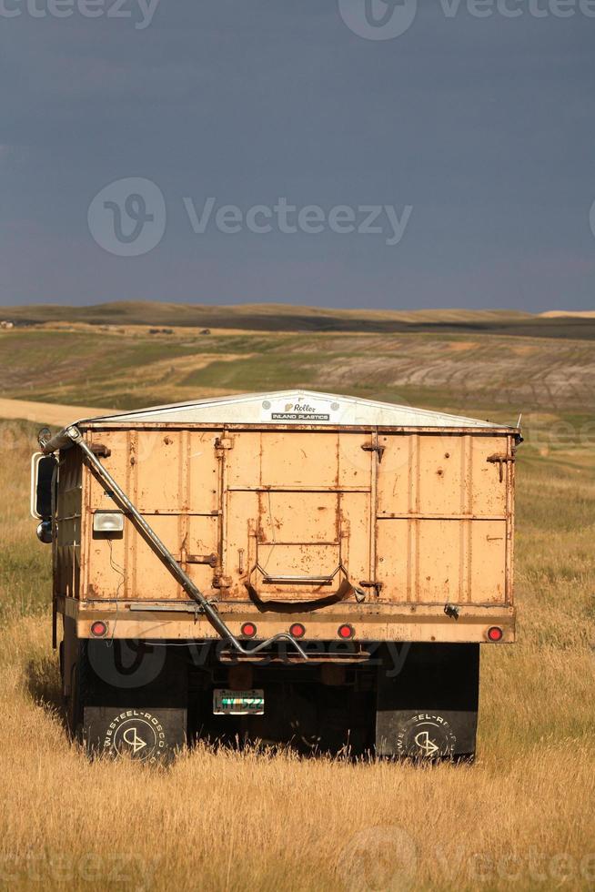 Grain truck and storm clouds in scenic Saskatchewan photo