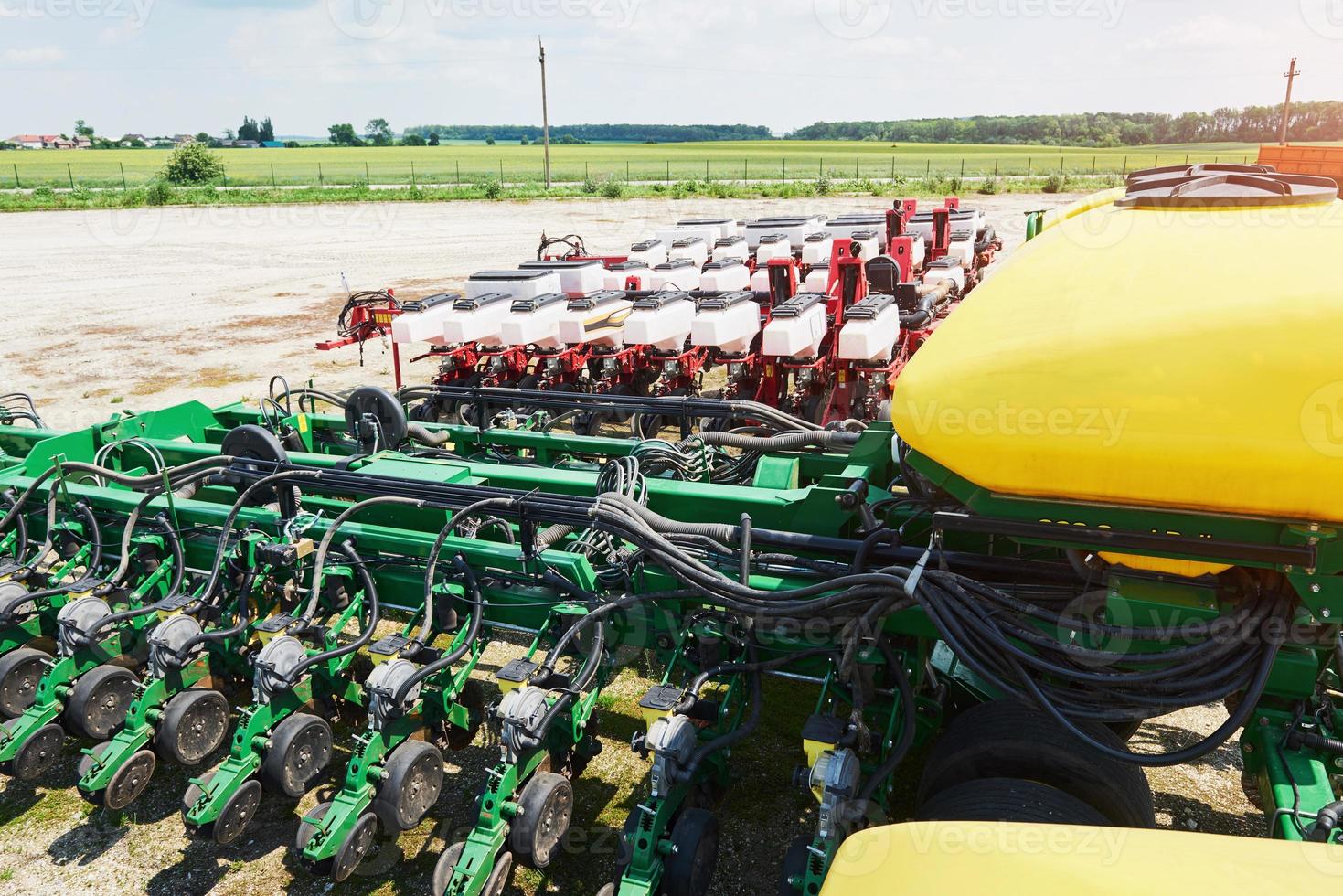 Close up of seeder attached to tractor in field. Agricultural machinery for spring works sowing photo