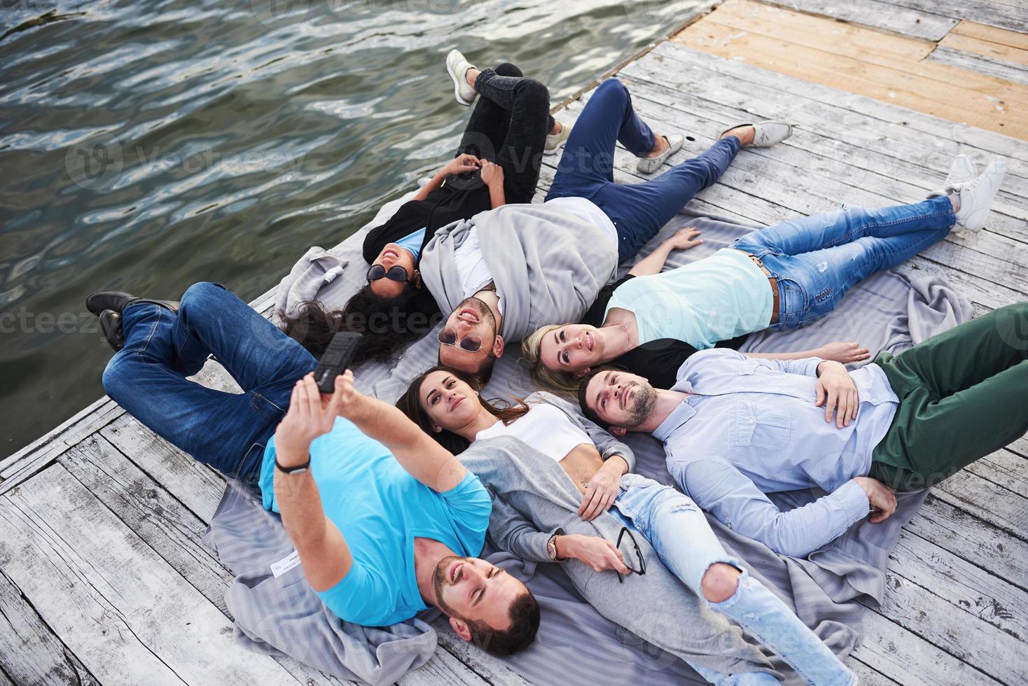 Group of happy beautiful young people who are doing Village on the pier, the best friends of girls and boys with the notion of pleasure creates emotional lives photo