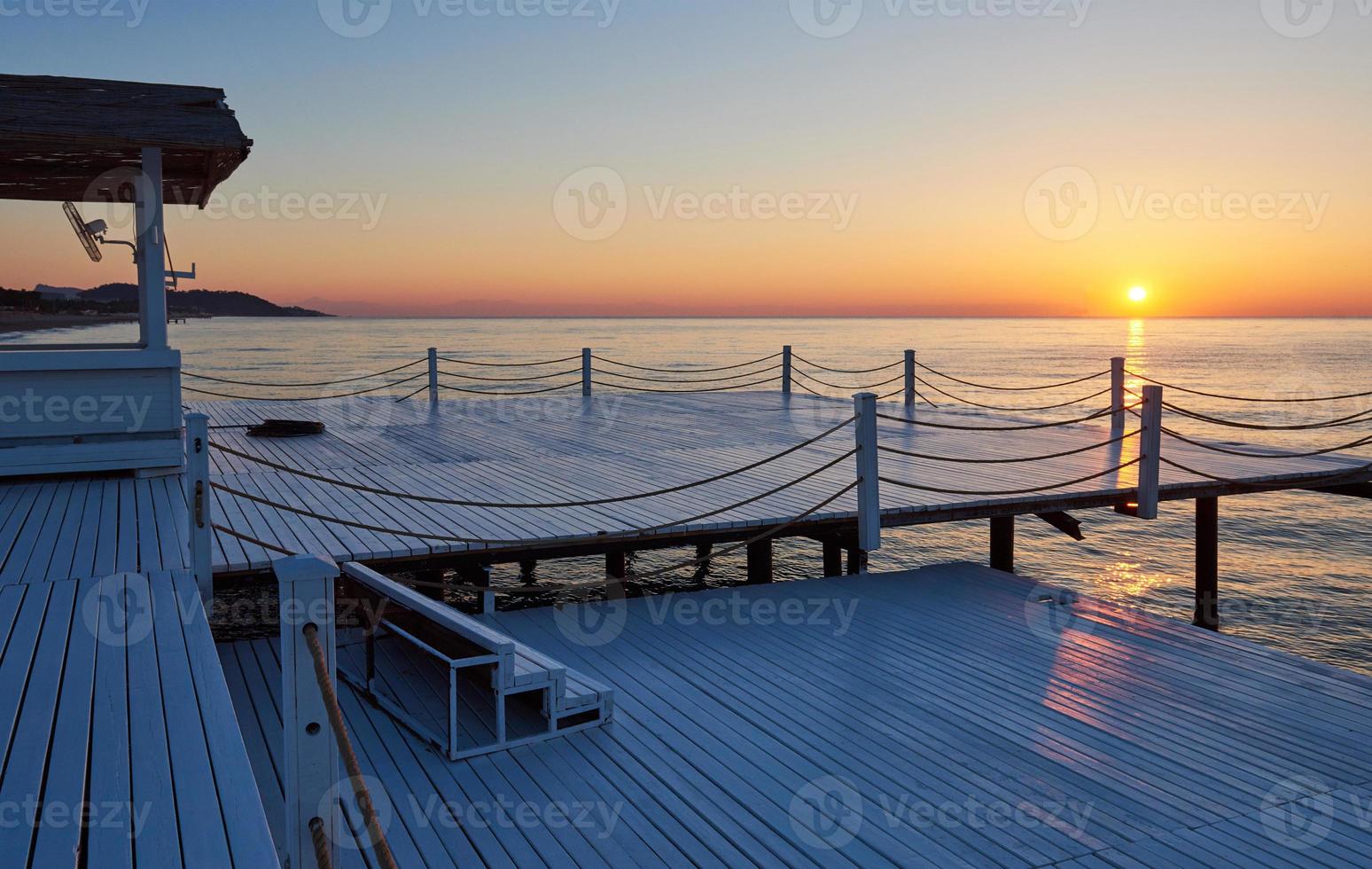 Wooden bridge pier against a beautiful sky measure used for natural background, background and multi-stage sea photo