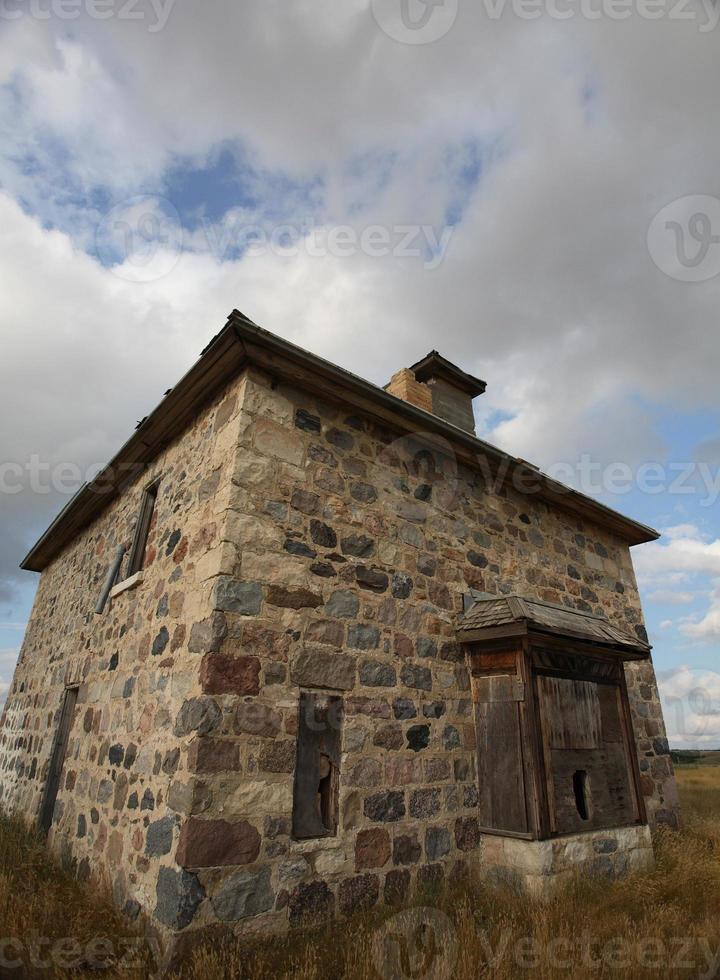 Abandoned stone house in scenic Saskatchewan photo