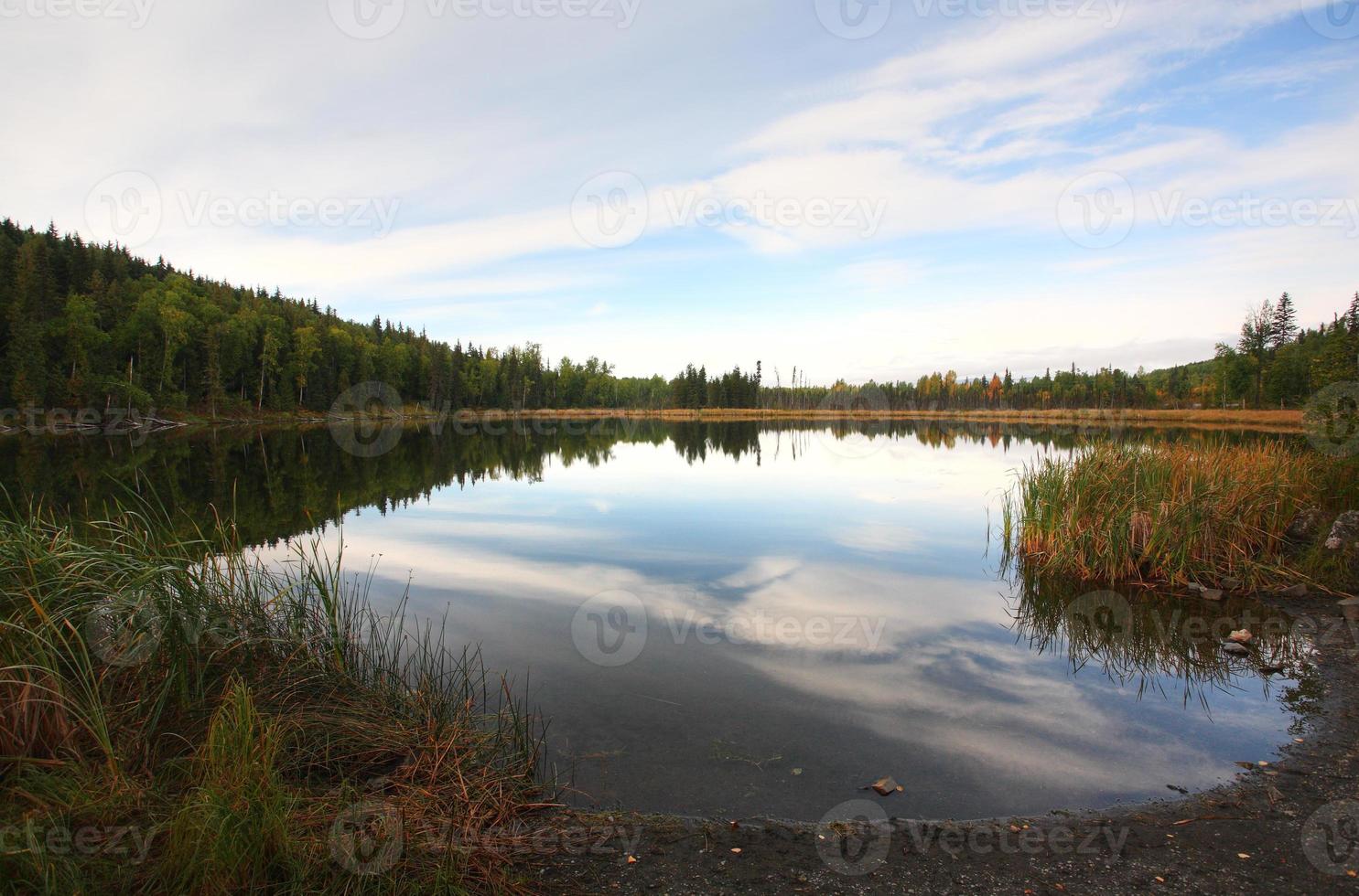 Reflections on a mountain lake in British Columbia photo