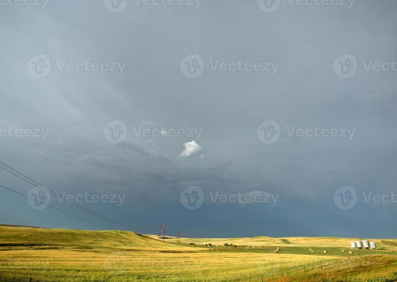 Storm clouds behind power lines in Saskatchewan photo