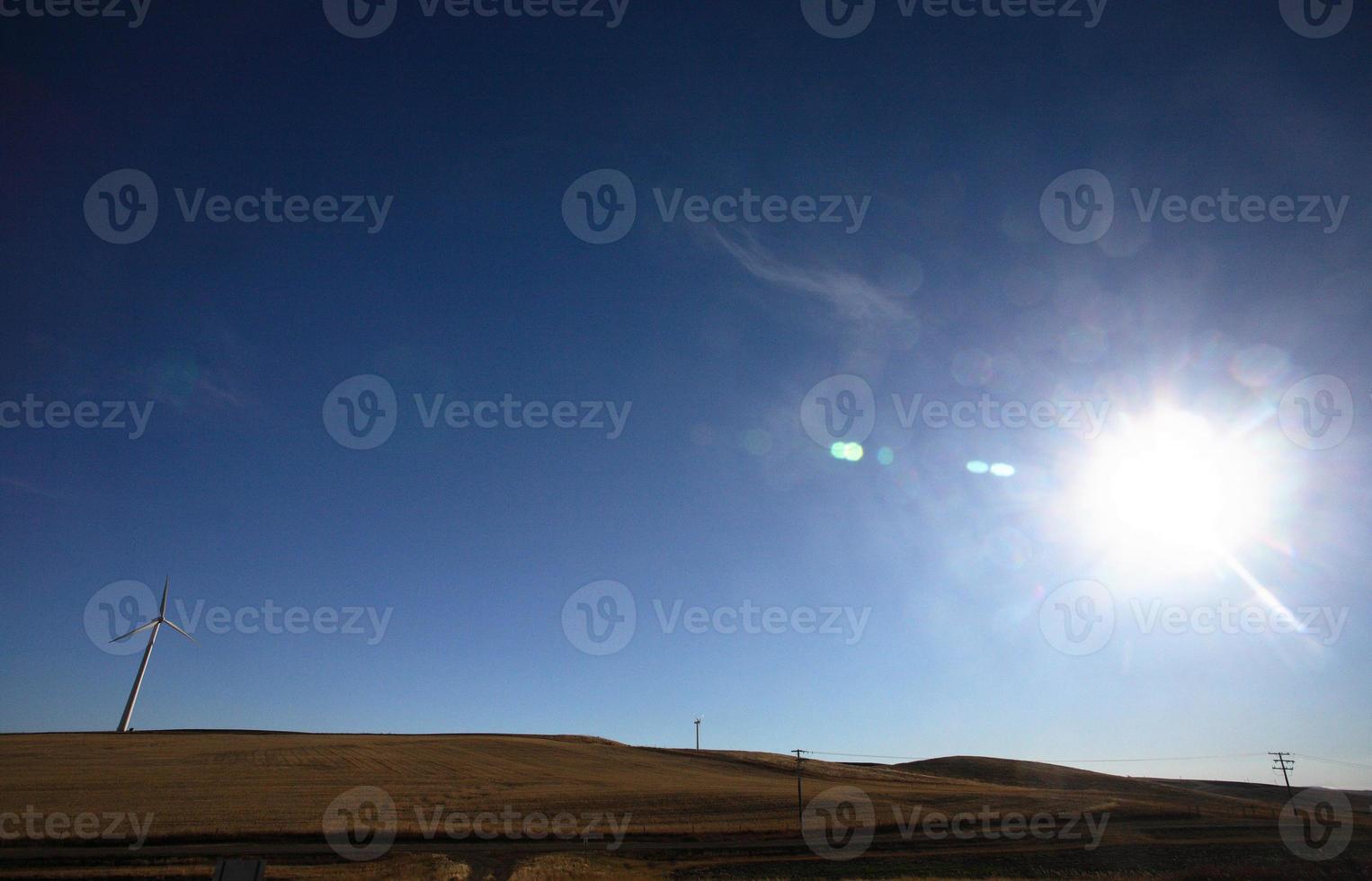 Sun setting behind Saskatchewan windfarm photo