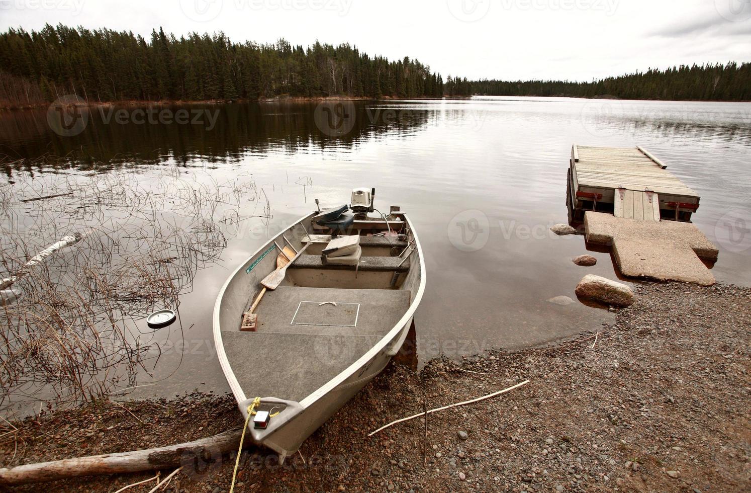 beached motor boat on Northern Manitoba lake photo