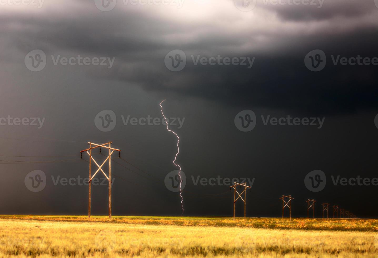 Lightning striking behind Saskatchewan power line photo
