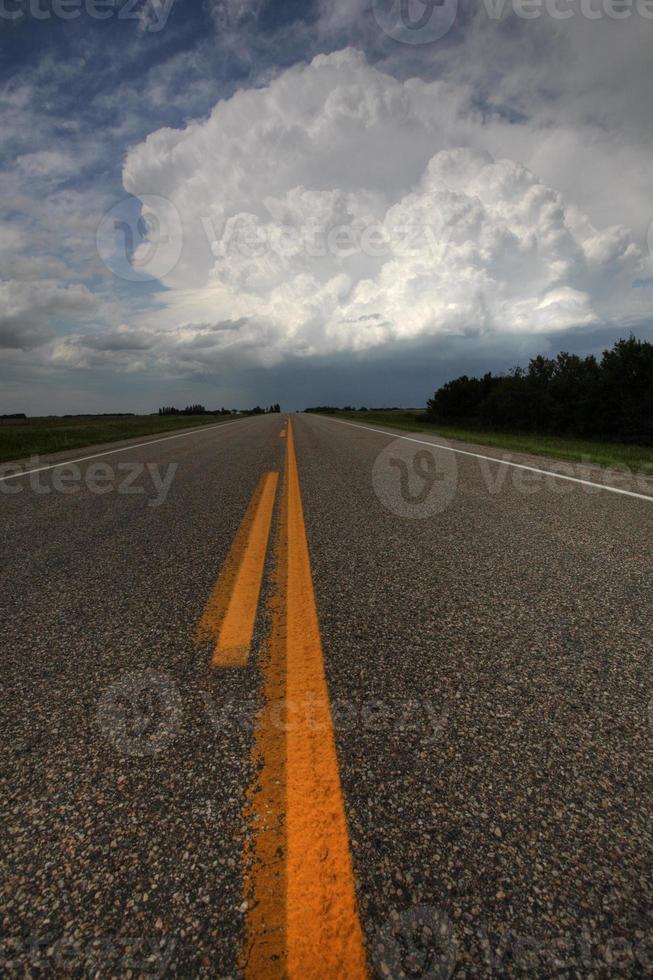 Storm clouds down a Saskatchewan highway photo