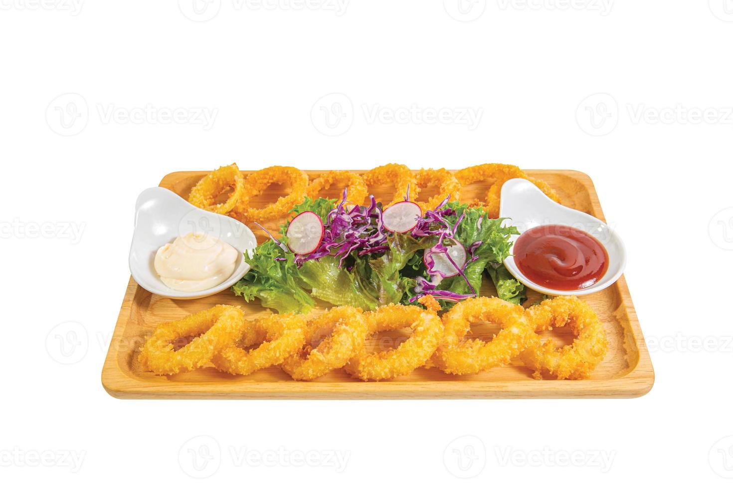 Fried onions with flour or onion ring, served with mayonase sauce, vegetable and tomatoes. photo