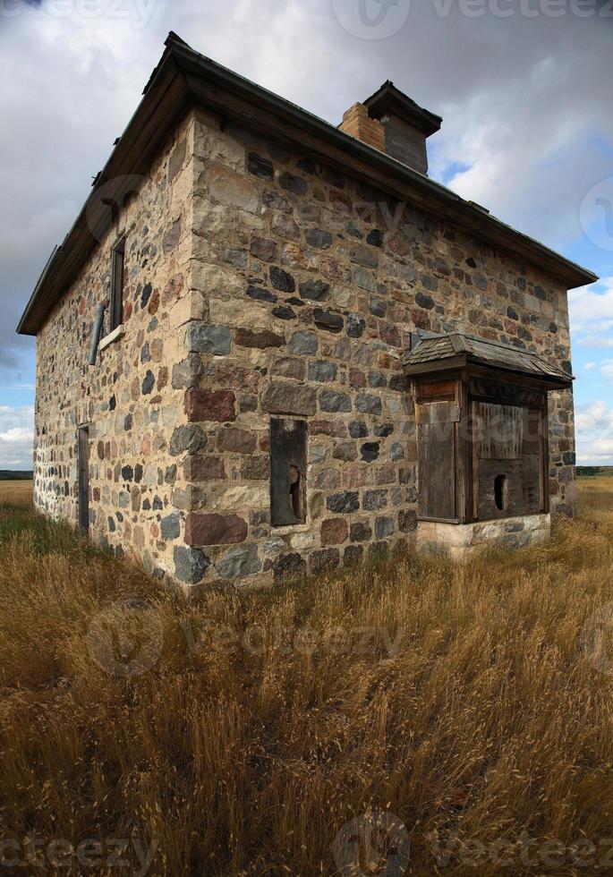 Abandoned stone house in scenic Saskatchewan photo