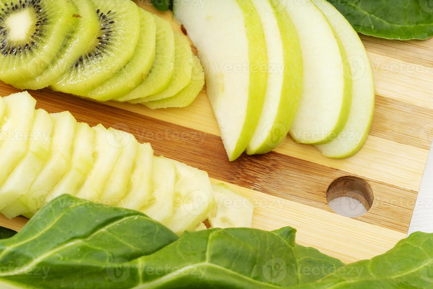 Kiwi with apples and sliced cucumbers photo