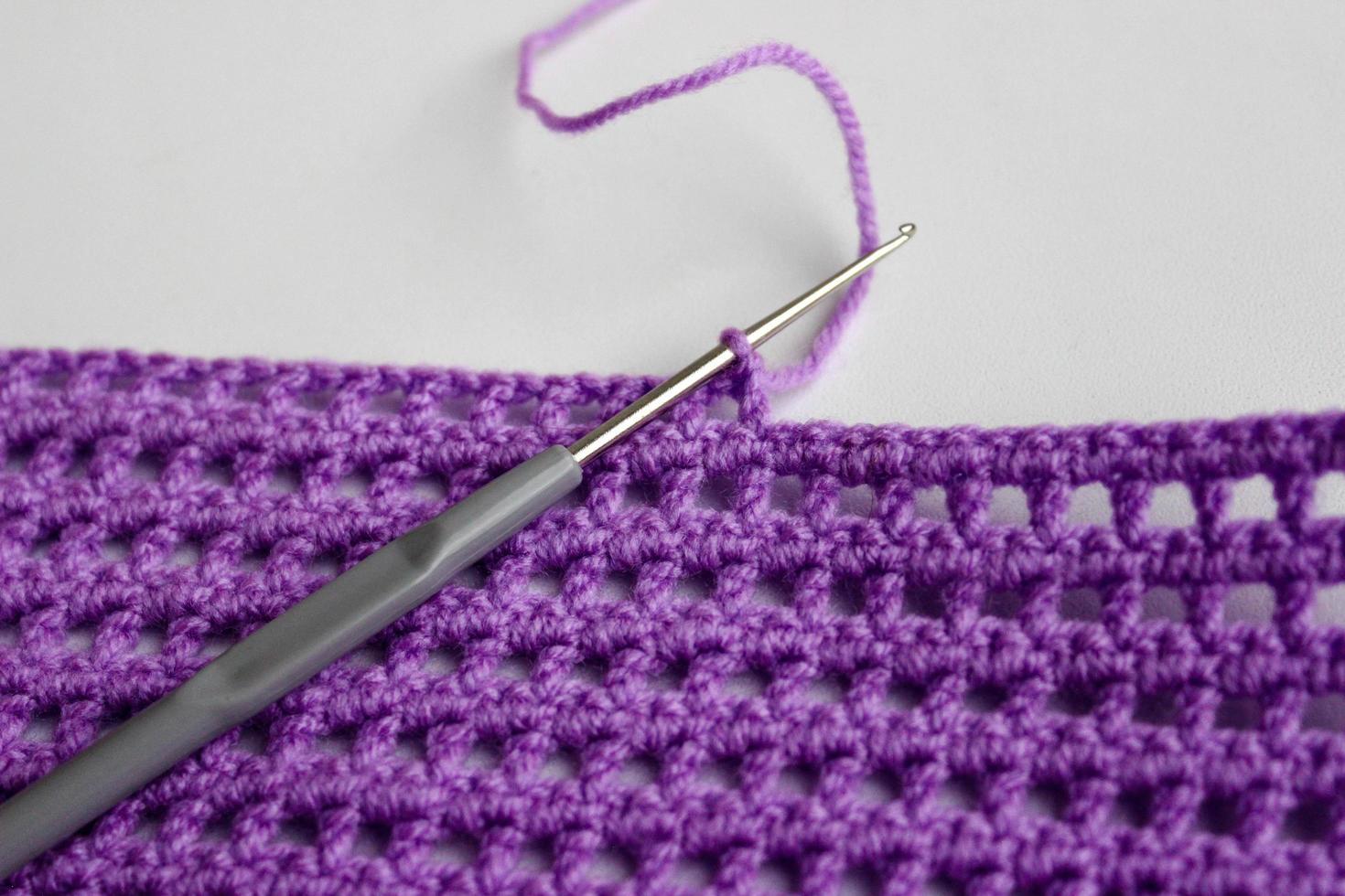 Crochet hook and thread in handmade process photo