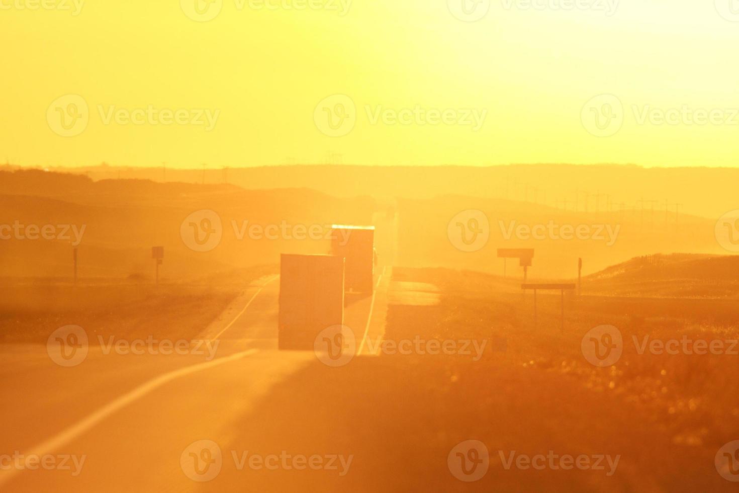 Semi trucks and sun glare along Trans Canada Highway photo