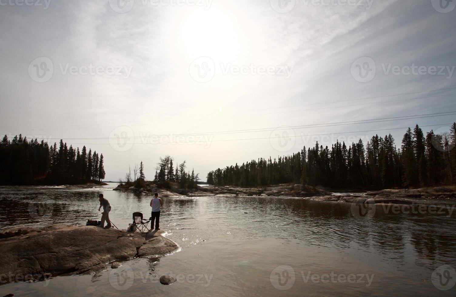 fisherrmen above Pisew Falls in Northern Manitoba photo