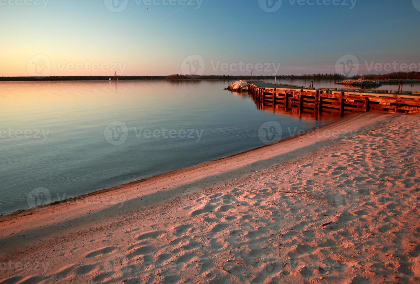 Beach and dock along shore of Lake Winnipeg photo