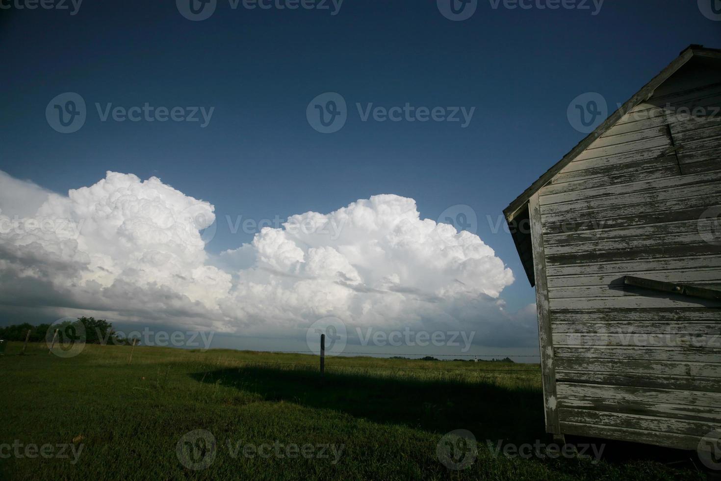 Storm clouds behind old Saskatchewan granary photo