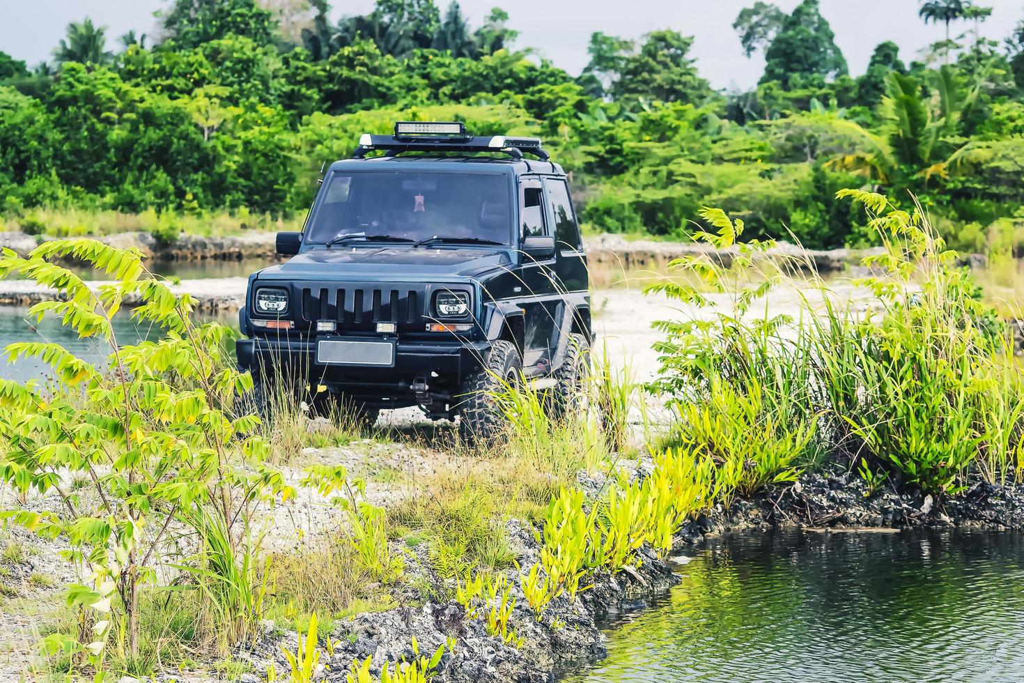 An old car at the edge of the pond photo