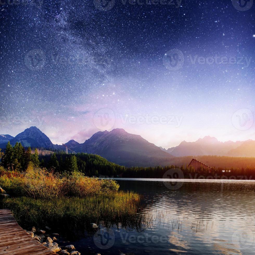 Fantastic starry sky and the milky way over a lake in the park High Tatras. Shtrbske Pleso, Slovakia, Europe photo