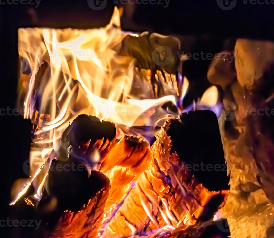 Beautiful old fireplace with light flame fire for heating building room photo