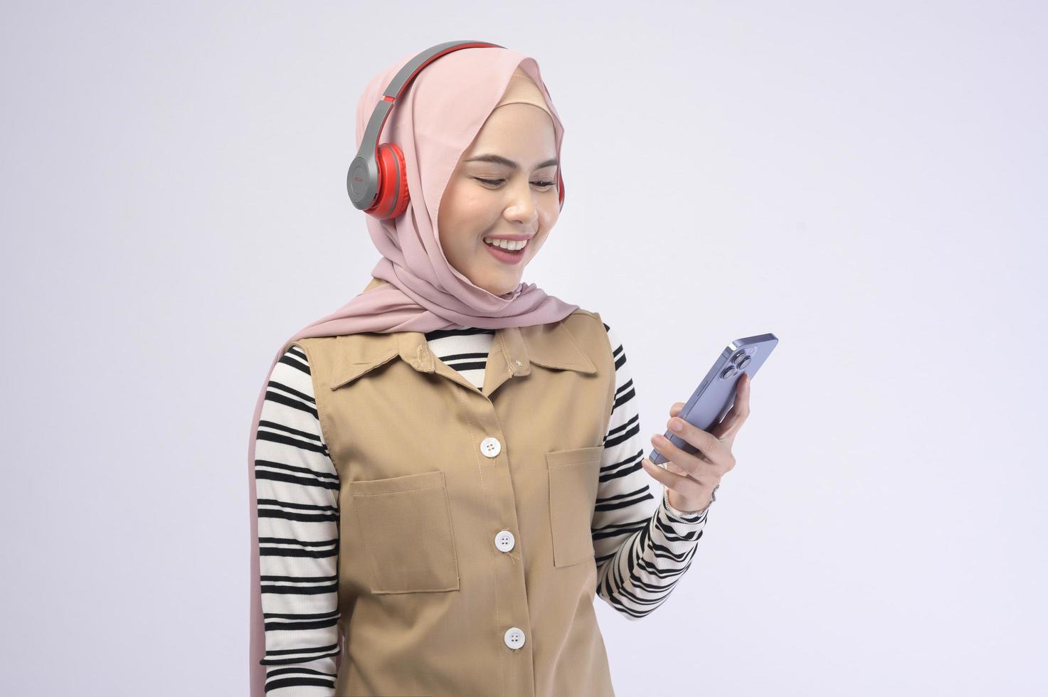 Young beautifu musliml woman wearing headset on white background photo