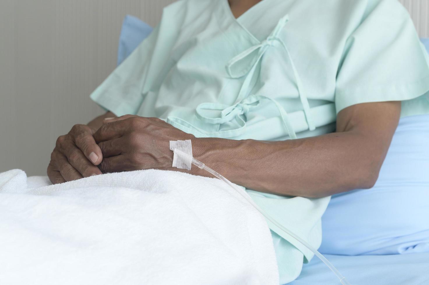 Portrait of senior patient lying on bed in hospital, healthcare and medical concept photo