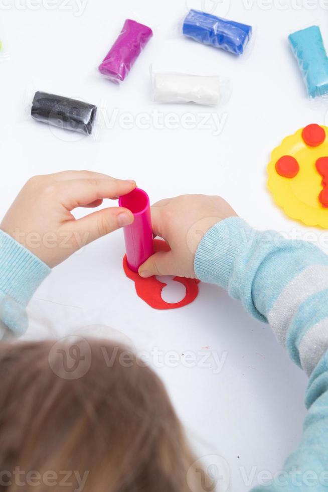 Childrens hands play dough for children's creativity. Board game for the development of fine motor skills photo