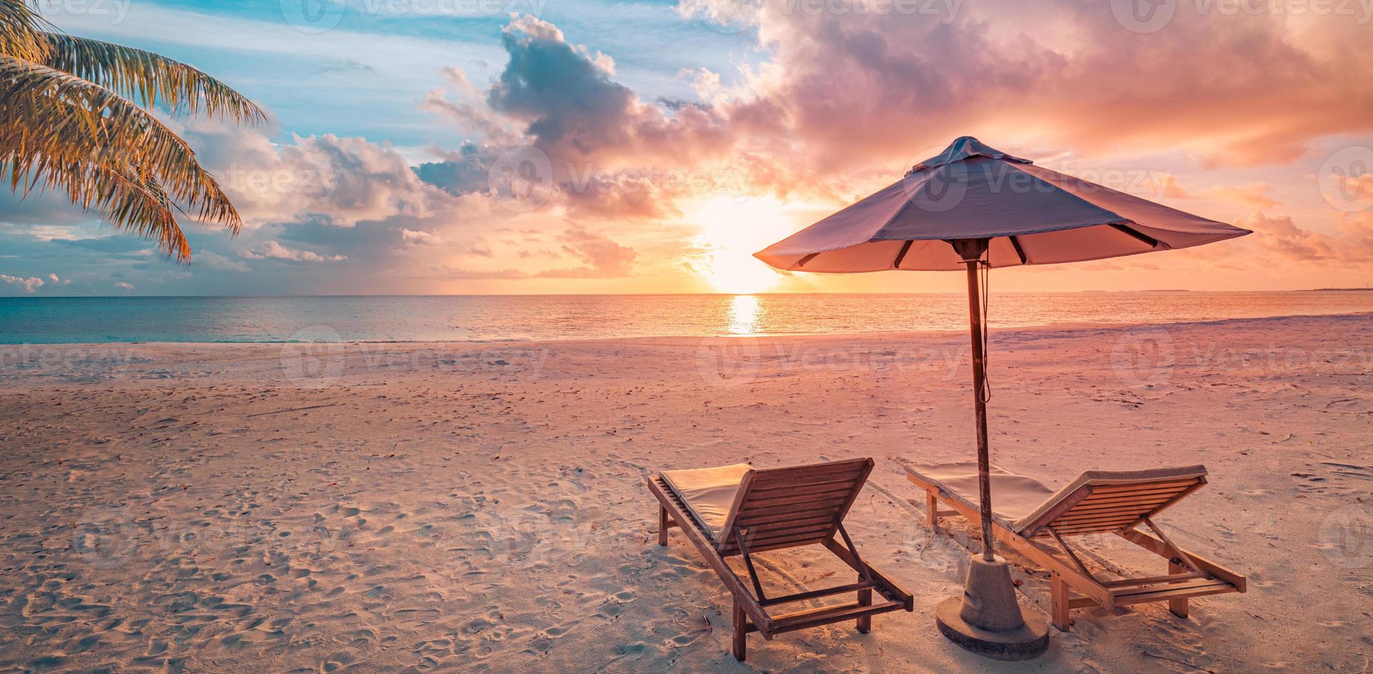 Amazing romantic beach. Chairs on the sandy beach near the sea. Summer holiday vacation concept for tourism. Tropical island landscape. Tranquil shore scenery, relax seaside horizon, palm leaves photo