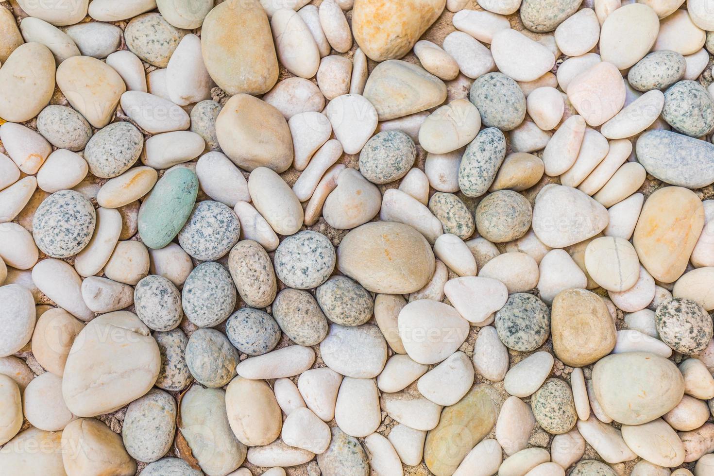 Abstract smooth round pebbles sea texture background. White bright pebbles background, simplicity, daylight, stones photo