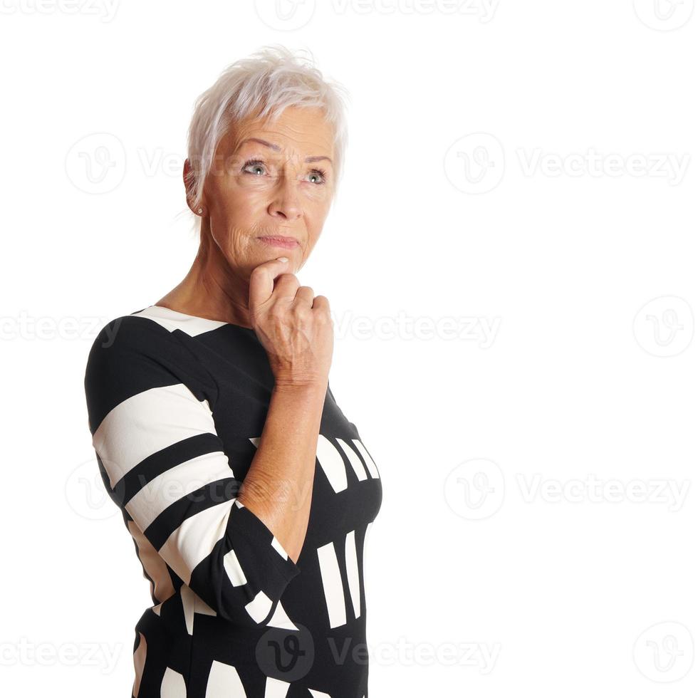 contemplative older woman looking up photo