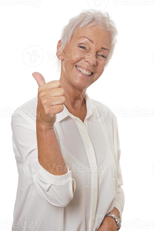 happy mature woman giving thumbs up photo