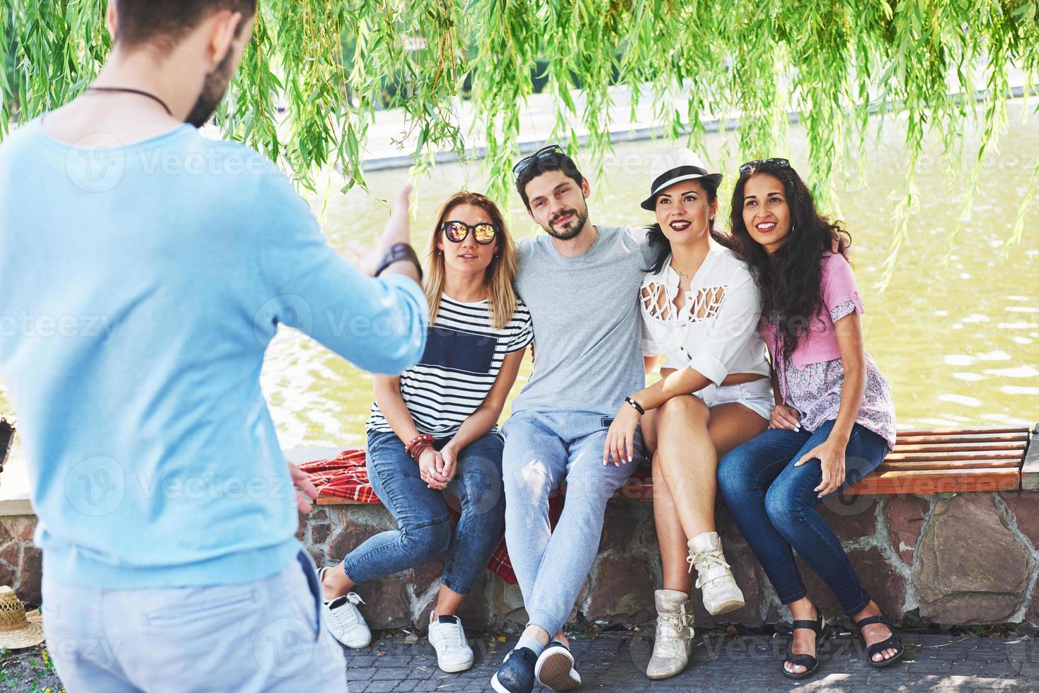 Group of friends relaxing and playing together. Young people chat on the streets, weigh and play games together photo