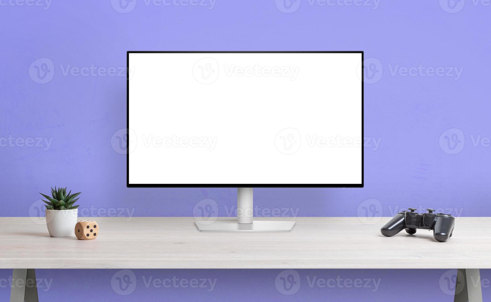 Computer display with isolated screen for mockup on desk. Gamepad, plant and cube beside. Gamer desk concept photo